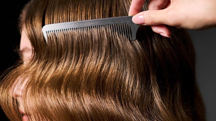 Comb running through smooth, healthy hair